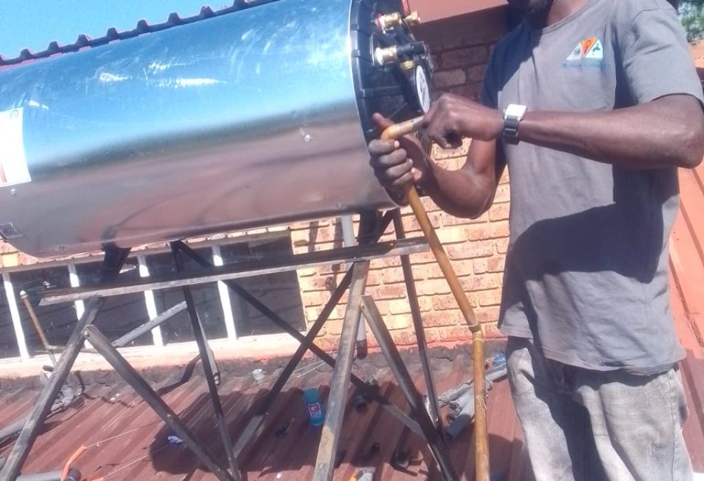 Technician repairing a solar geyser in Randburg